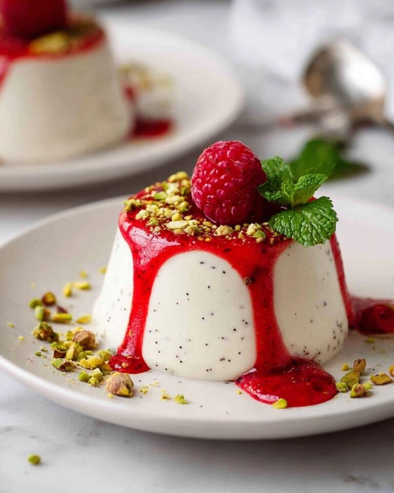 Creamy Vanilla Panna Cotta with Raspberry Coulis and Pistachio Garnish Recipe