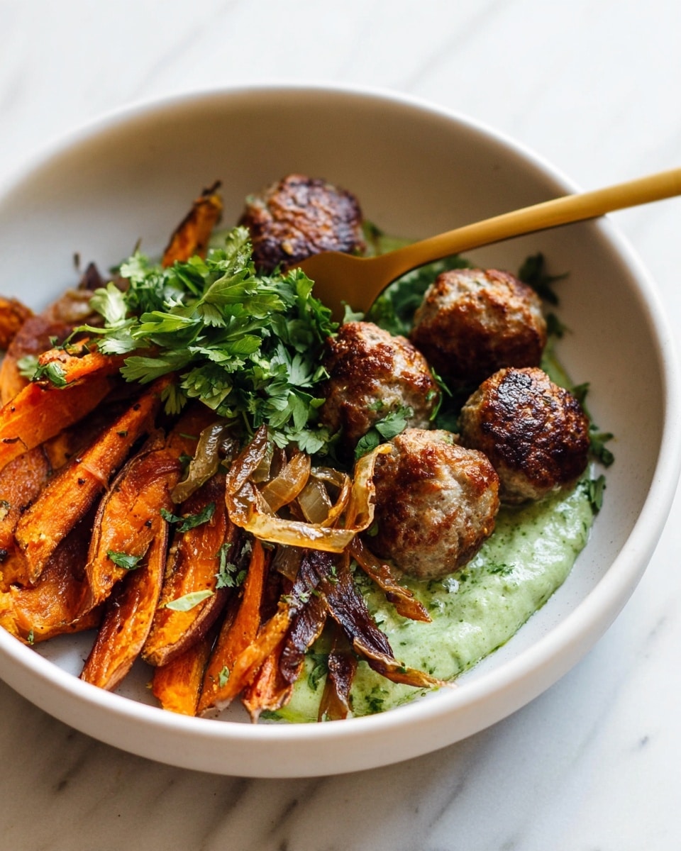 A white bowl holds a dish layered with several browned meatballs scattered in the upper half, sitting partly on a pale green creamy sauce that lines the bottom. Below the meatballs, there are roasted orange sweet potato wedges with a slightly burnt edge, topped with thin, crispy, caramelized onion strips. A small bunch of fresh, bright green parsley is placed near the back of the bowl. A gold fork rests on top of the vegetables, with its prongs touching one meatball. The bowl is set against a white marbled surface. photo taken with an iphone --ar 4:5 --v 7
