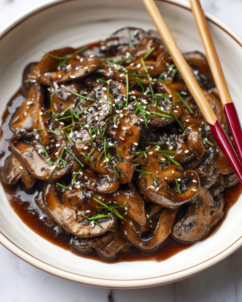 A white bowl filled with several layers of cooked brown mushrooms covered in a thick, glossy dark brown sauce. The mushrooms are sliced and layered unevenly, with some pieces on top overlapping others. The dish is sprinkled with small white and black sesame seeds and finely chopped green chives that add a fresh contrast to the deep colors below. Resting on the edge of the bowl are light wooden chopsticks with red tips. The bowl sits on a white marbled surface. photo taken with an iphone --ar 4:5 --v 7