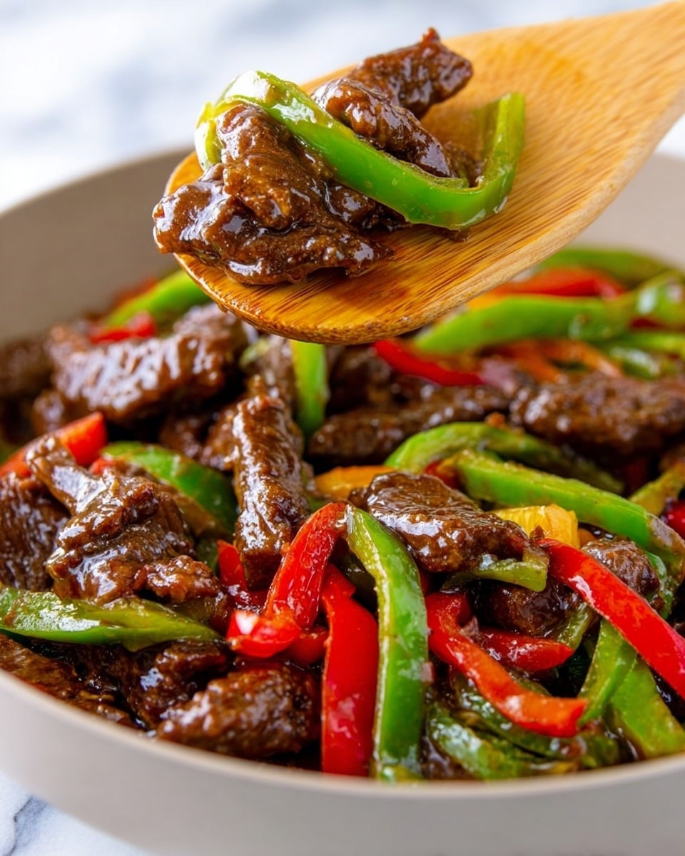 The image shows a close-up of a dish with slices of dark brown, glossy cooked meat mixed with bright green and red bell pepper strips. The meat pieces have a shiny sauce coating, giving a moist look. The peppers are long, slender, and appear slightly cooked but still crisp. A light wooden spatula is lifting a piece of meat and a green pepper strip from a white bowl filled with the colorful mixture. The background shows a white marbled surface. photo taken with an iphone --ar 4:5 --v 7