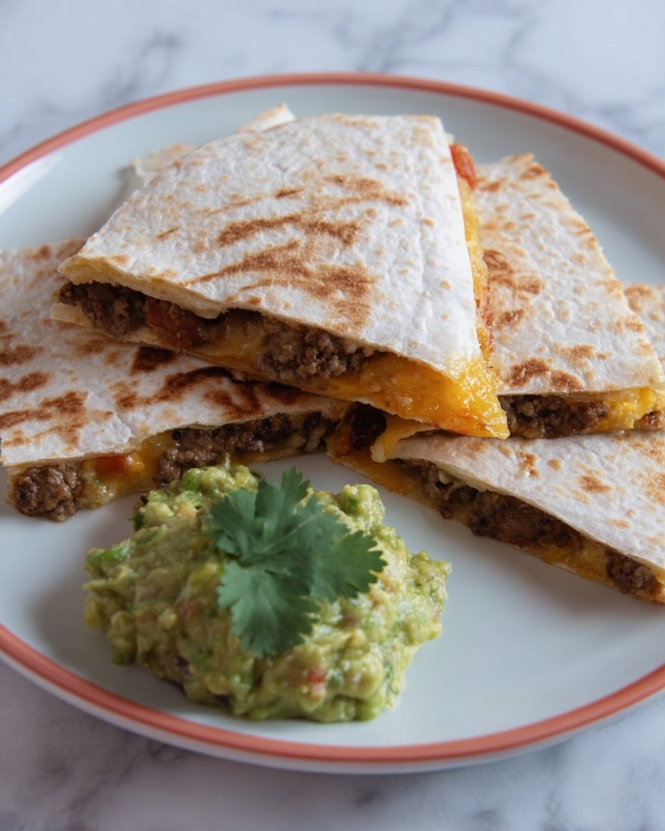 The image shows three triangular pieces of quesadilla stacked on a white plate. Each quesadilla layer has a lightly browned, toasted white tortilla with visible grill marks. Inside, the filling is a mix of browned ground meat and melted orange cheese, creating a soft texture between the tortilla layers. Next to the quesadilla pieces is a scoop of chunky green guacamole garnished with a bright green cilantro leaf. The plate rests on a white marbled surface. photo taken with an iphone --ar 4:5 --v 7