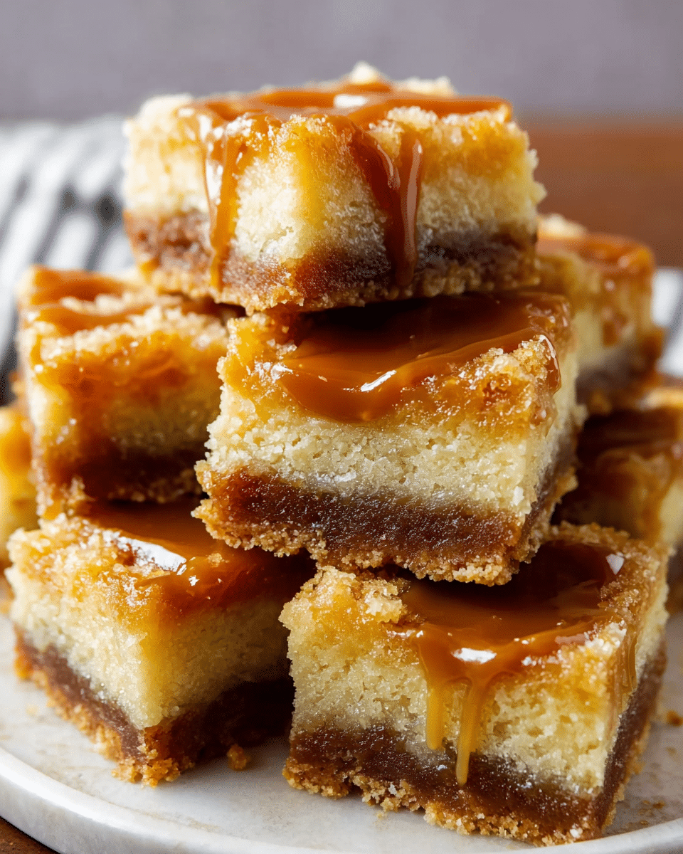 A close-up view of a stack of caramel-topped dessert bars sitting on a white plate with a white marbled texture background. Each bar has two clear layers: a thick, light golden-yellow top layer that looks soft and crumbly, and a darker brown bottom layer that appears dense and moist. A shiny caramel drizzle flows on top of the bars, adding a sticky, glossy texture. The bars are cut into squares, stacked unevenly to show their thickness and texture. Photo taken with an iphone --ar 4:5 --v 7