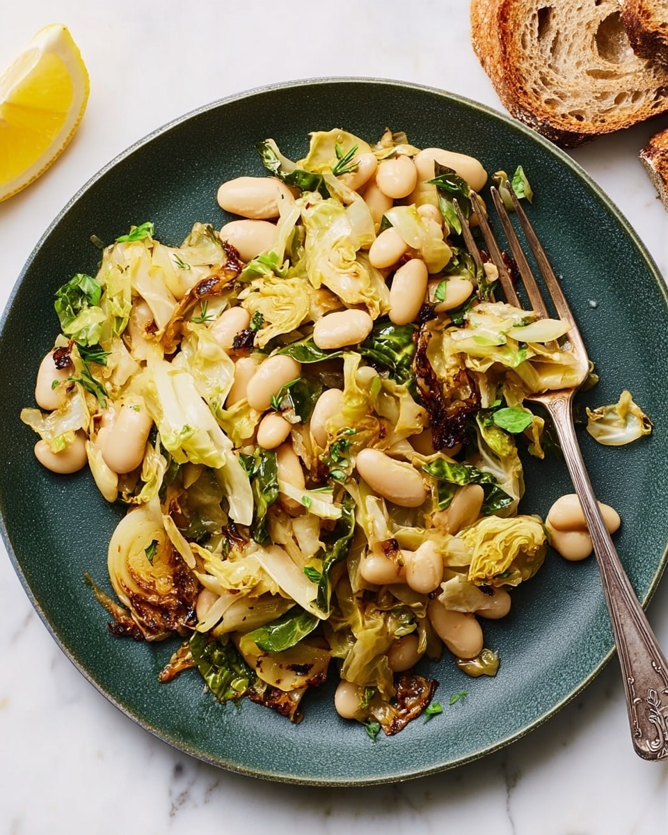 A dark green plate holds a dish with two main layers: the bottom layer is a mix of light green to golden brown cooked cabbage pieces with some crispy browned edges, while the top layer consists of large, smooth, off-white beans scattered evenly. There are small green herb leaves mixed throughout, adding a fresh color pop. A silver fork rests on the right side of the plate, holding some beans. A lemon wedge with bright yellow skin and pale flesh is placed near the upper left edge of the plate. Pieces of crusty brown bread are partially visible in the top right corner, all set on a white marbled surface. photo taken with an iphone --ar 4:5 --v 7