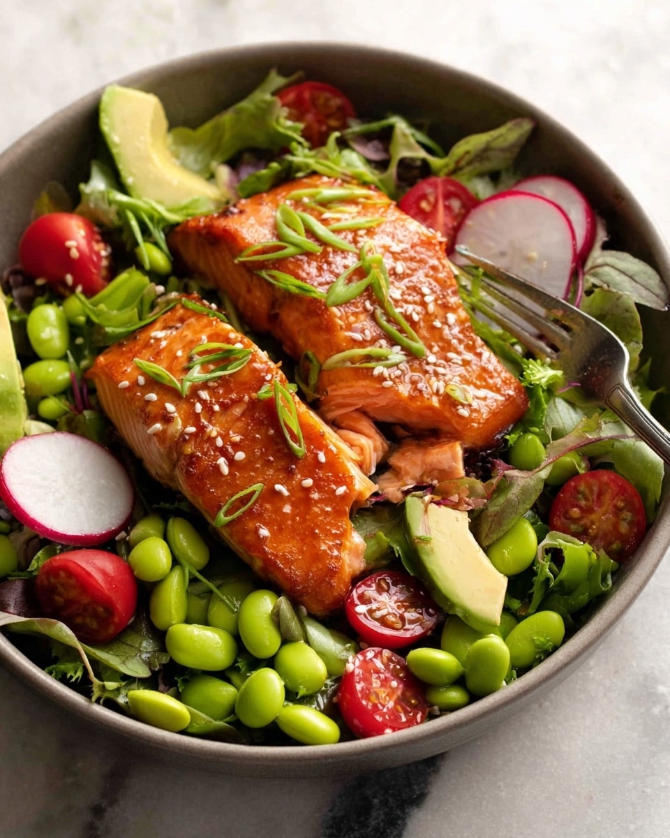 A white bowl holds a fresh salad with multiple layers: the bottom layer is a mix of green leafy vegetables, topped with bright green edamame beans and sliced red cherry tomatoes scattered around. On top, chunks of avocado and thin slices of radish add texture and color contrasts. The main focus is two pieces of glazed salmon with a shiny orange-brown crust, sprinkled with white sesame seeds and chopped green onions. A fork cuts into one salmon piece, showing the soft pink inside. The entire dish sits on a white marbled surface. photo taken with an iphone --ar 4:5 --v 7