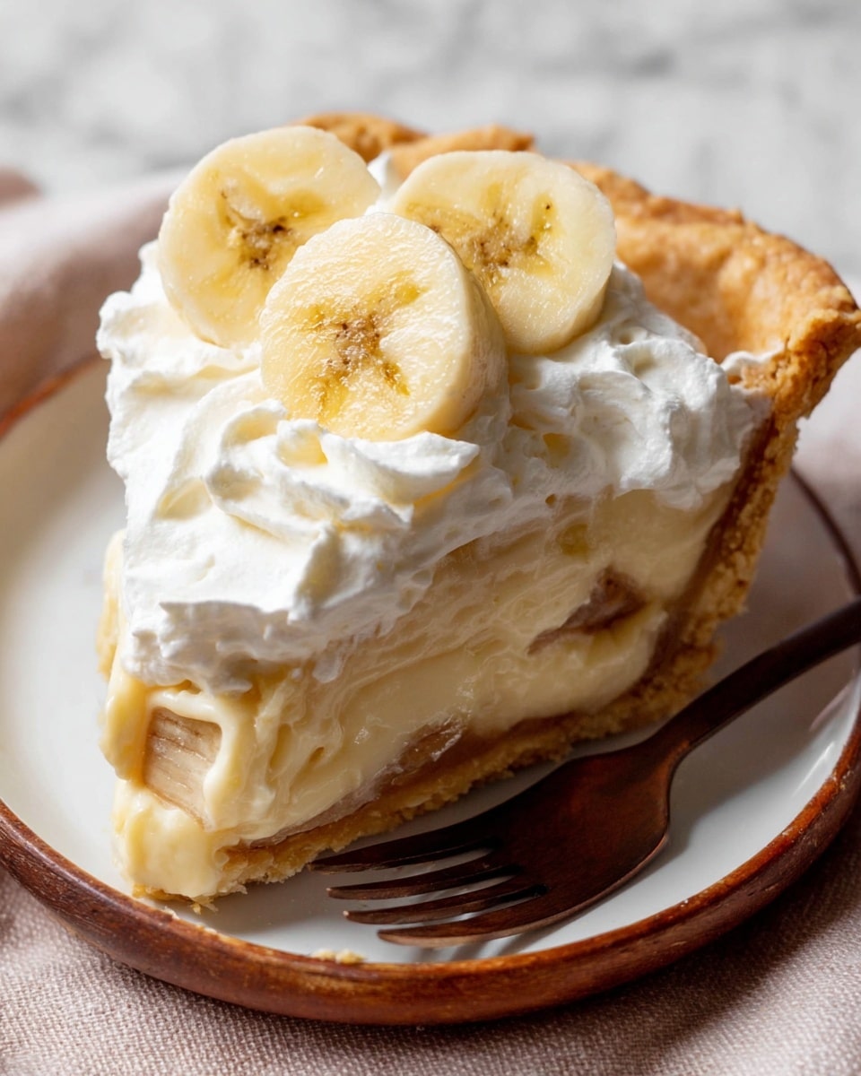 A slice of banana cream pie is shown on a white plate with a brown fork. The bottom layer is a golden, flaky crust. Above it is a creamy, pale yellow banana filling that looks smooth and thick. On top of the filling is a layer of white whipped cream with soft, swirled peaks. Three banana slices, light yellow with small dark spots, rest on the whipped cream. The background is a white marbled texture. photo taken with an iphone --ar 4:5 --v 7