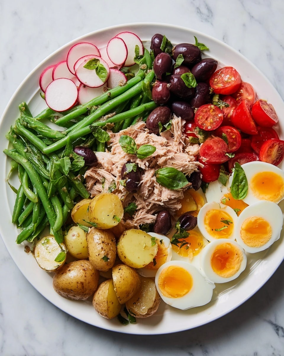A white plate holds a colorful salad with six layers arranged in sections. Starting from the left, there are thinly sliced radishes with white centers and pink edges, topped with small green basil leaves. Next, bright green cooked string beans mixed with small dark purple black olives and basil leaves are placed in the middle left. Below the beans are halved baby potatoes in light brown and yellow tones with a sprinkling of herbs. In the top center, there is a pile of pale pink flaked tuna garnished with black olive slices and basil. On the right side, halved bright red cherry tomatoes with some basil leaves sit next to the tuna. The bottom right section has six halved soft-boiled eggs with white edges and bright orange yolks, also sprinkled with a few olive slices and small basil leaves. The whole plate is on a white marbled surface. Photo taken with an iphone --ar 4:5 --v 7