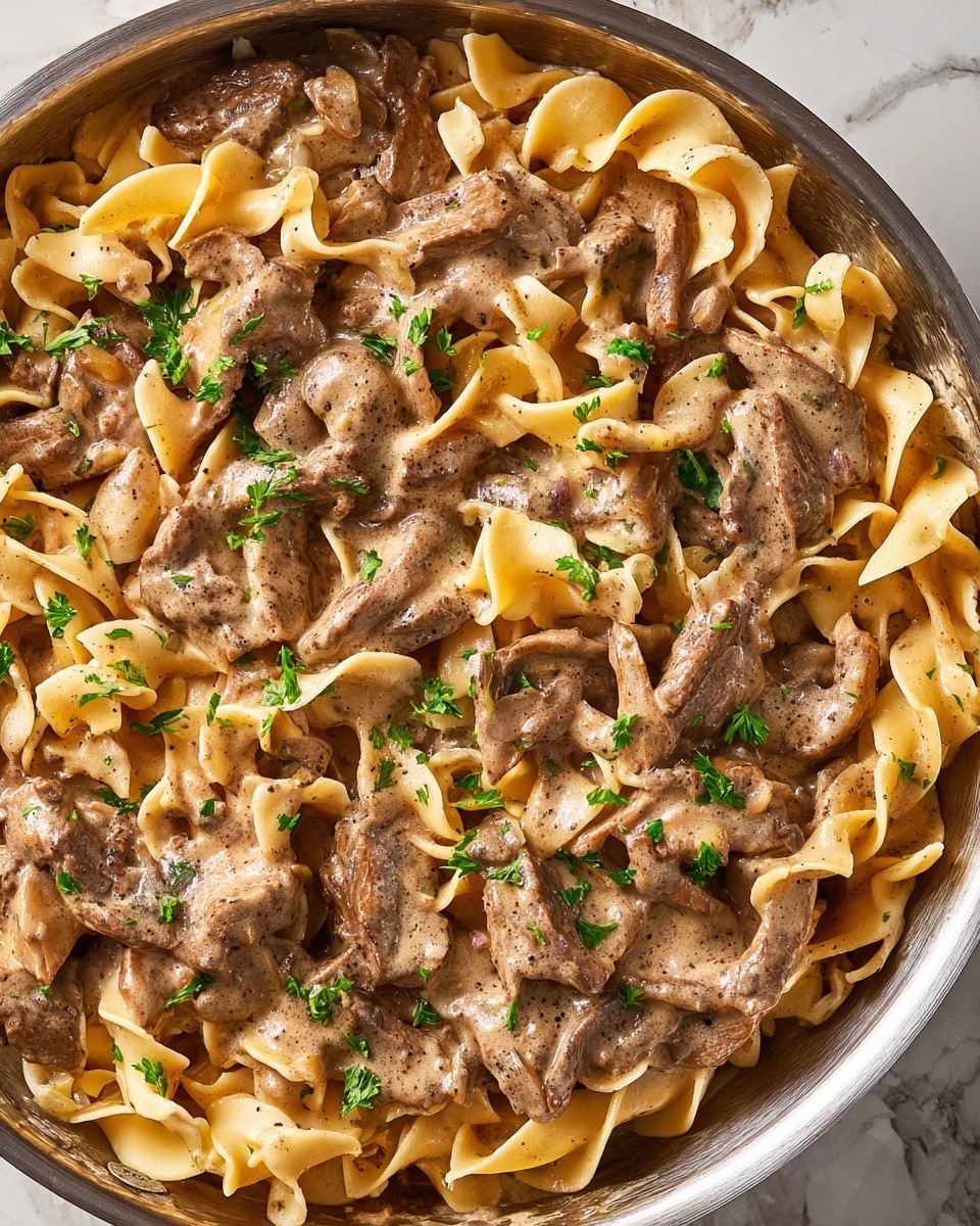 The image shows a close-up of golden-brown sautéed mushroom slices cooked in a pan. The mushrooms are cut into uneven, thick slices with a glossy, slightly oily texture on their surface. They sit directly on the light brown interior of the pan, which has small browned bits and some oily spots, adding to the rich look of the cooking process. The overall colors are warm shades of brown with a shiny, moist appearance. The focus is tight, emphasizing the texture and color of the mushrooms. photo taken with an iphone --ar 4:5 --v 7