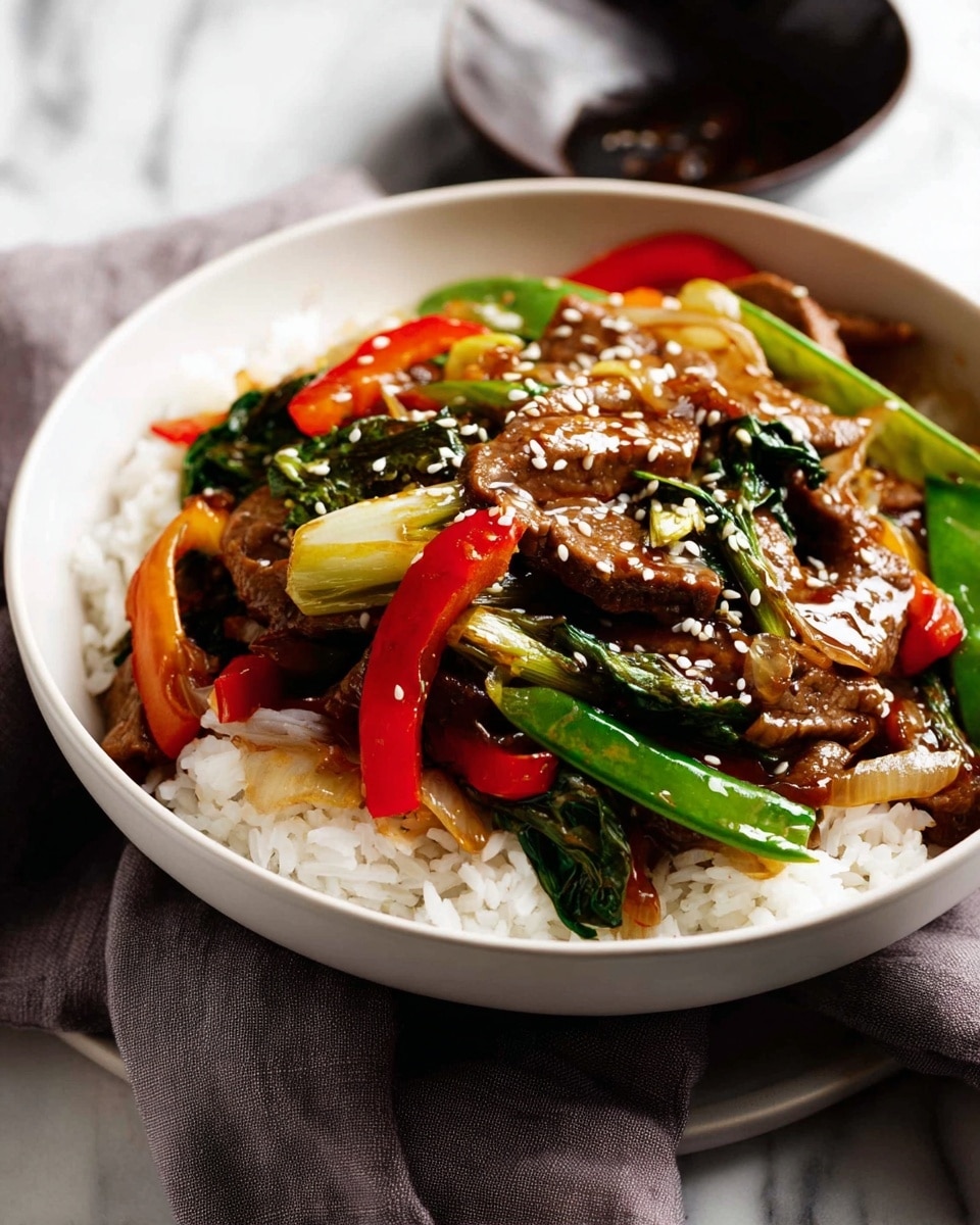 A white bowl filled with a base layer of fluffy white rice topped with a colorful stir-fry mix. The stir-fry consists of glossy brown slices of meat, bright green vegetables like bok choy and snap peas, vibrant red and orange bell pepper strips, and caramelized onions. The dish is sprinkled with white sesame seeds, adding texture and detail. The bowl is placed on a light gray cloth over a white marbled surface, with a small dark dish in the background. Photo taken with an iphone --ar 4:5 --v 7