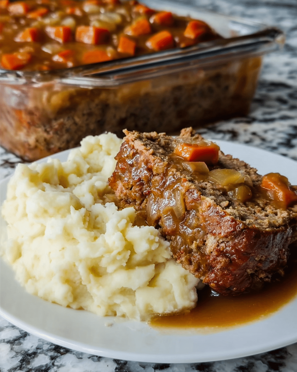 A white plate holds a meal with three main parts: the front shows a thick slice of meatloaf with a rough, crumbly texture mixed with visible small pieces of onion and browned edges, sitting on a layer of bright orange cooked carrots covered partly in brown gravy. To the left of the meatloaf are creamy, pale yellow mashed potatoes with a smooth and slightly lumpy texture. In the background, a clear rectangular glass dish is filled with a rich, dark brown meat sauce with chunks of ground meat and orange carrot pieces visible. The whole setup is on a white marbled surface. Photo taken with an iphone --ar 4:5 --v 7