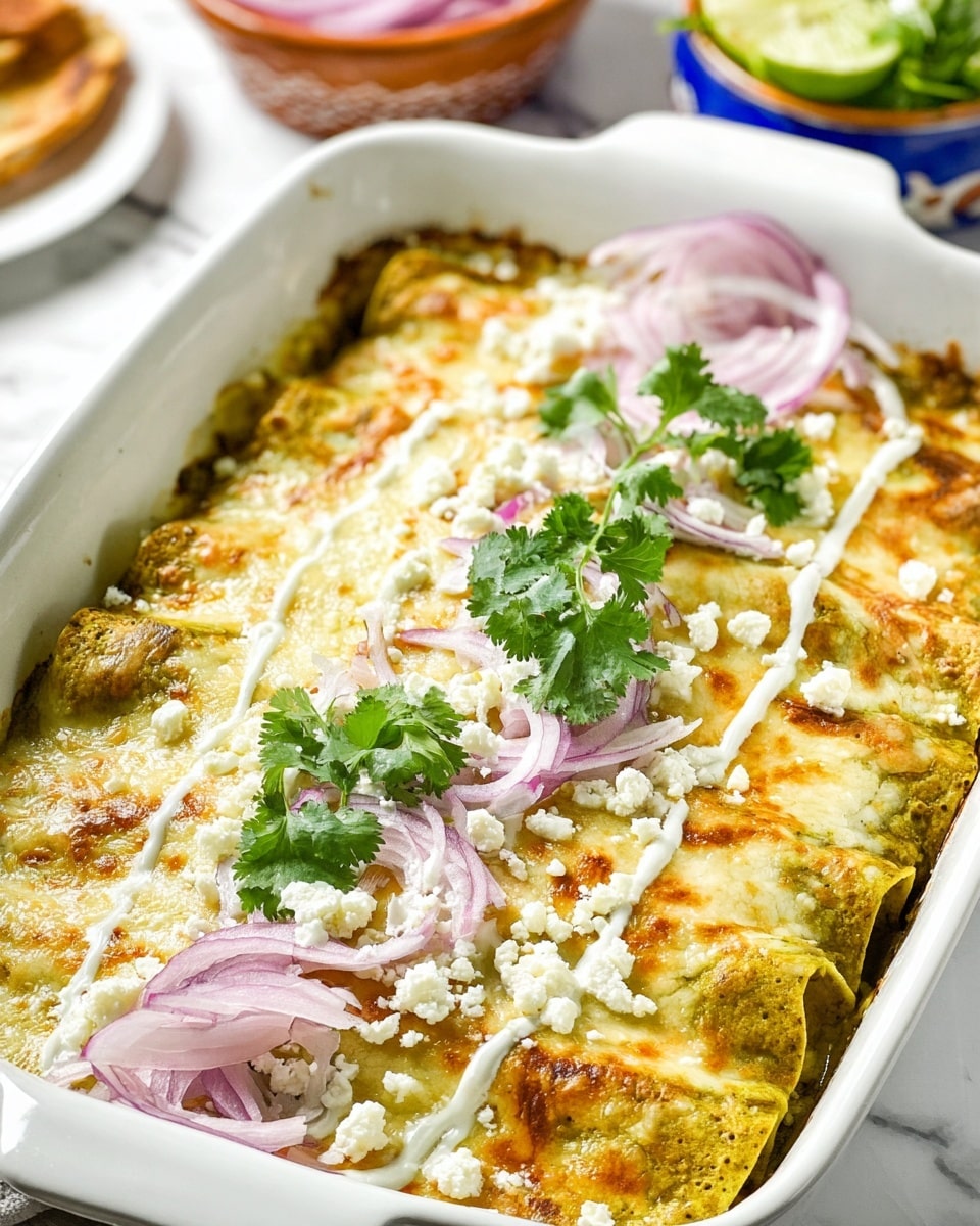A white baking dish holds several rolled green and yellow enchiladas, topped with melted golden and light brown cheese, drizzled in white creamy sauce. On one side, there are thin slices of purple onion, fresh green cilantro leaves, and crumbled white cheese for garnish. The dish is placed on a white marbled surface with some soft focus dishes in the background. photo taken with an iphone --ar 4:5 --v 7