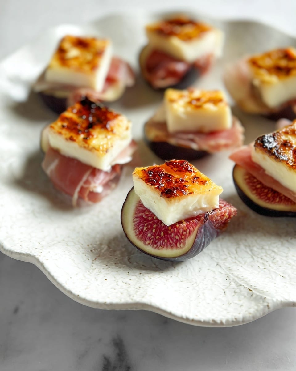 The dish shows several small appetizers on a white scalloped plate with a subtle texture. Each appetizer has three visible layers: the bottom is a dark purple sliced fig with a textured pink and red inside, the middle layer is thin pale pink prosciutto folded gently, and the top layer is a square piece of creamy white cheese with a caramelized golden brown crust. The appetizers are spaced evenly on the plate that is placed on a white marbled surface. Photo taken with an iphone --ar 4:5 --v 7