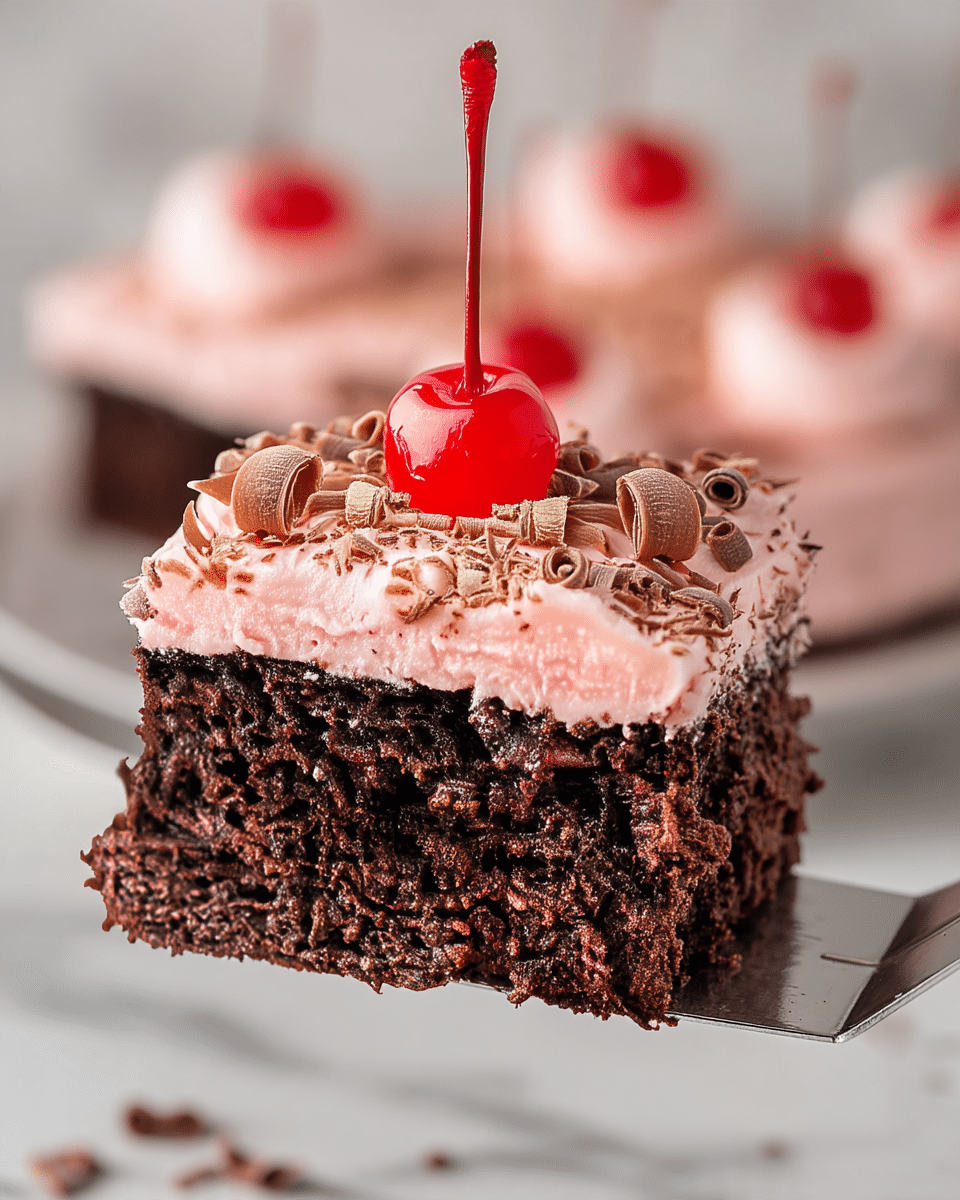 A slice of chocolate cake is lifted on a spatula, showing two layers: a thick, dark brown, moist chocolate cake base and a thick light pink frosting layer on top. The frosting is smooth and topped with curly chocolate shavings and a bright red cherry with its stem in the center. The rest of the cake, with the same layered look and frosting decoration with cherries and chocolate curls, is on a white marbled surface in the background. Photo taken with an iphone --ar 4:5 --v 7