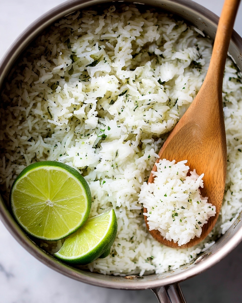 Inside a silver Instant Pot, there is a close-up view of cooked white rice mixed with small green bits of cilantro, giving it a textured look. In the bottom left corner of the rice, there are two wedges of fresh green lime adding a pop of color. A wooden spoon is scooping some rice, the smooth wood handle extending out of the pot towards the top right. Outside the pot, on a white marbled surface, there is a small white bowl holding several lime wedges, and some fresh green cilantro leaves are scattered near the bottom right corner. The overall scene looks clean and fresh with a bright natural light. photo taken with an iphone --ar 4:5 --v 7