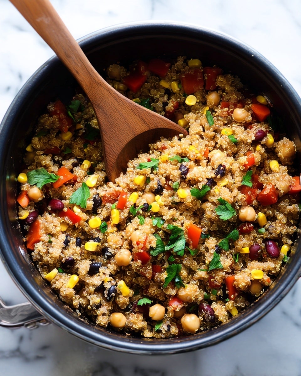 Inside a black slow cooker, there is a mix of cooked quinoa showing as small, soft, light tan grains forming the main layer. Scattered throughout are bright yellow corn kernels, small dark black beans, light beige chickpeas, and chunks of red bell pepper adding bursts of color. Fresh green cilantro leaves are sprinkled on top, giving a fresh texture contrast. A wooden spoon is resting inside, slightly mixing the ingredients. The background is a white marbled texture. Photo taken with an iphone --ar 4:5 --v 7